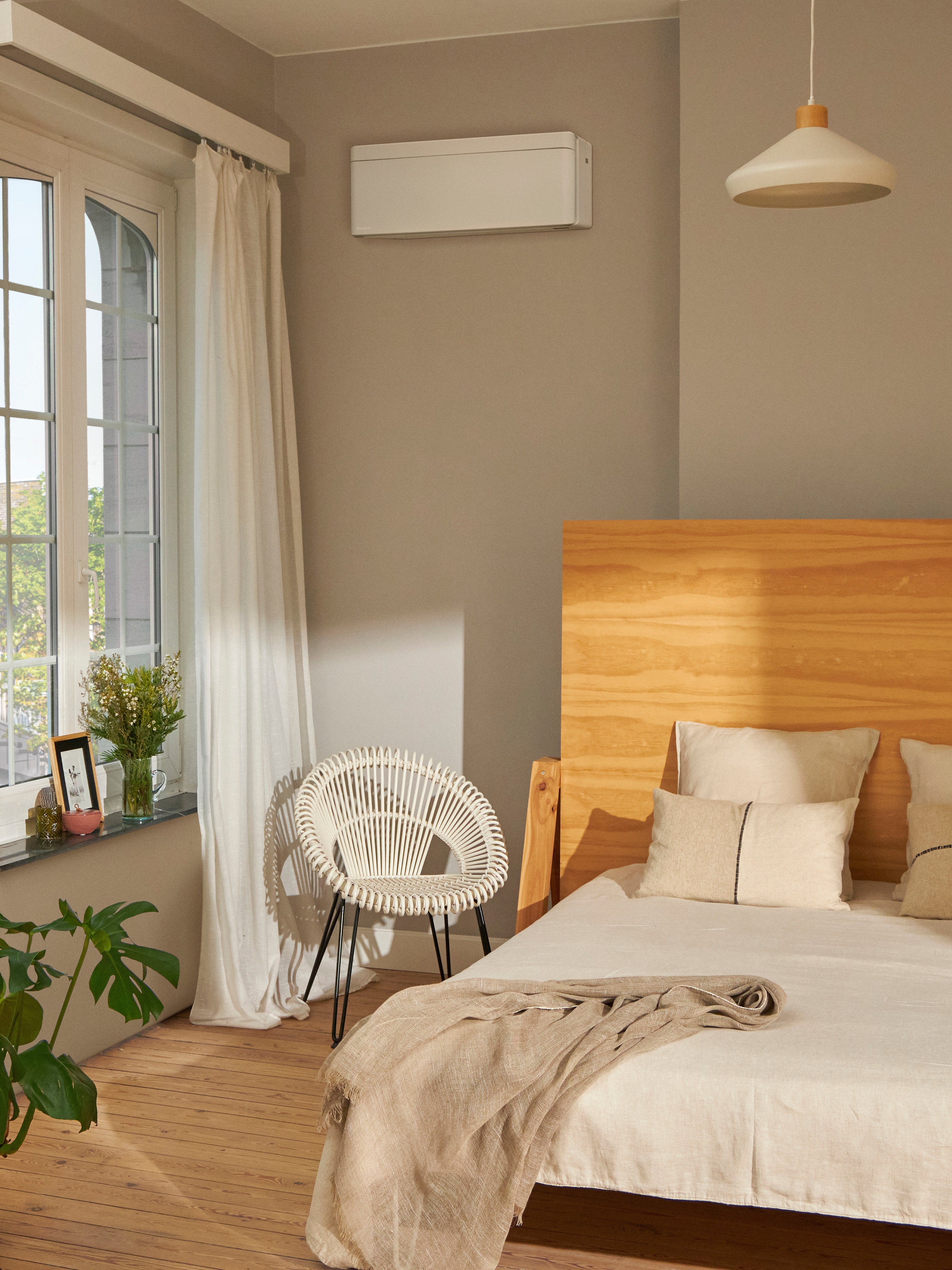 Beautiful bedroom featuring a white wall-mounted climate system