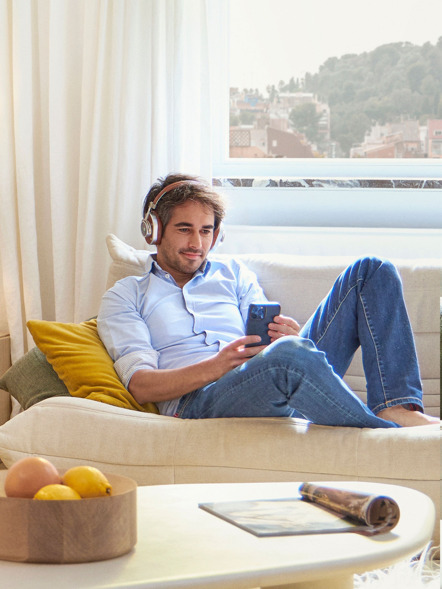 Man relaxing in this living room exploring options to save money